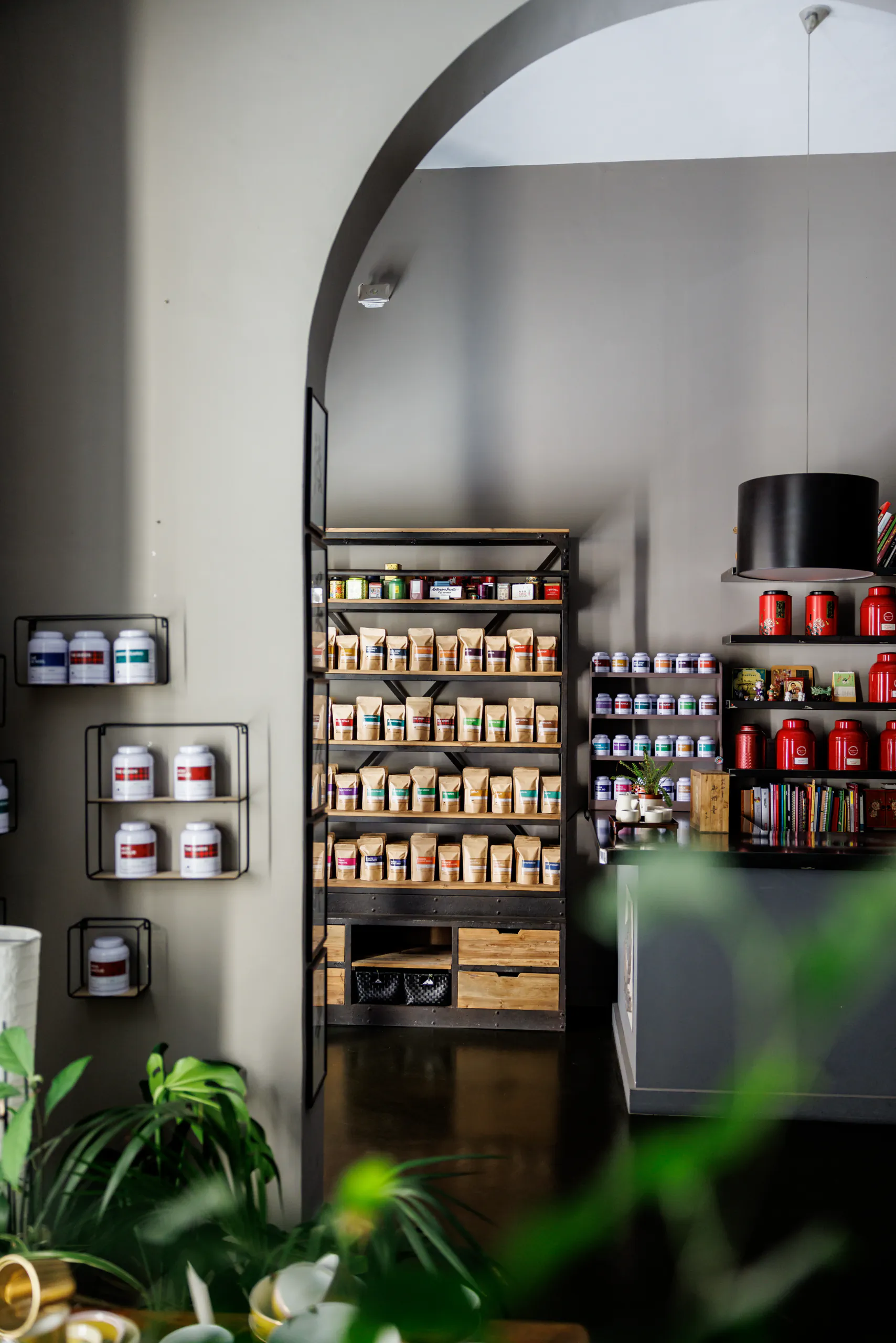 Spa shelves lined with wellness products under an arch