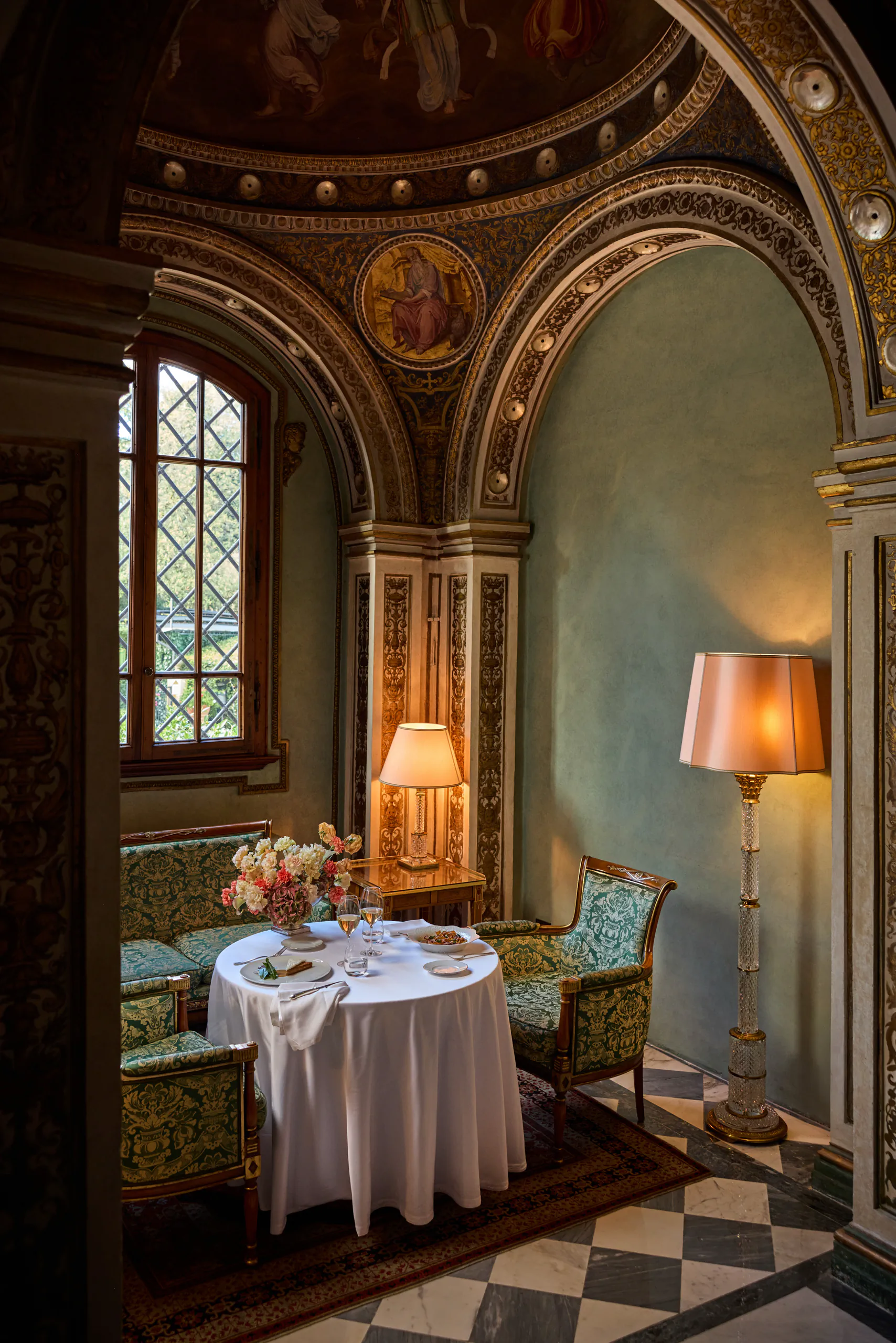 Ornate frescoed dining room with a set table for two — Four Seasons, Florence